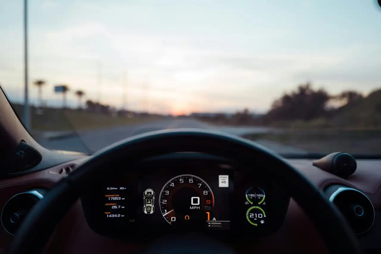 A digital automotive instrument cluster displaying a steering failure warning, illustrating HMI safety mechanisms and ISO 26262 compliance for vehicle displays.